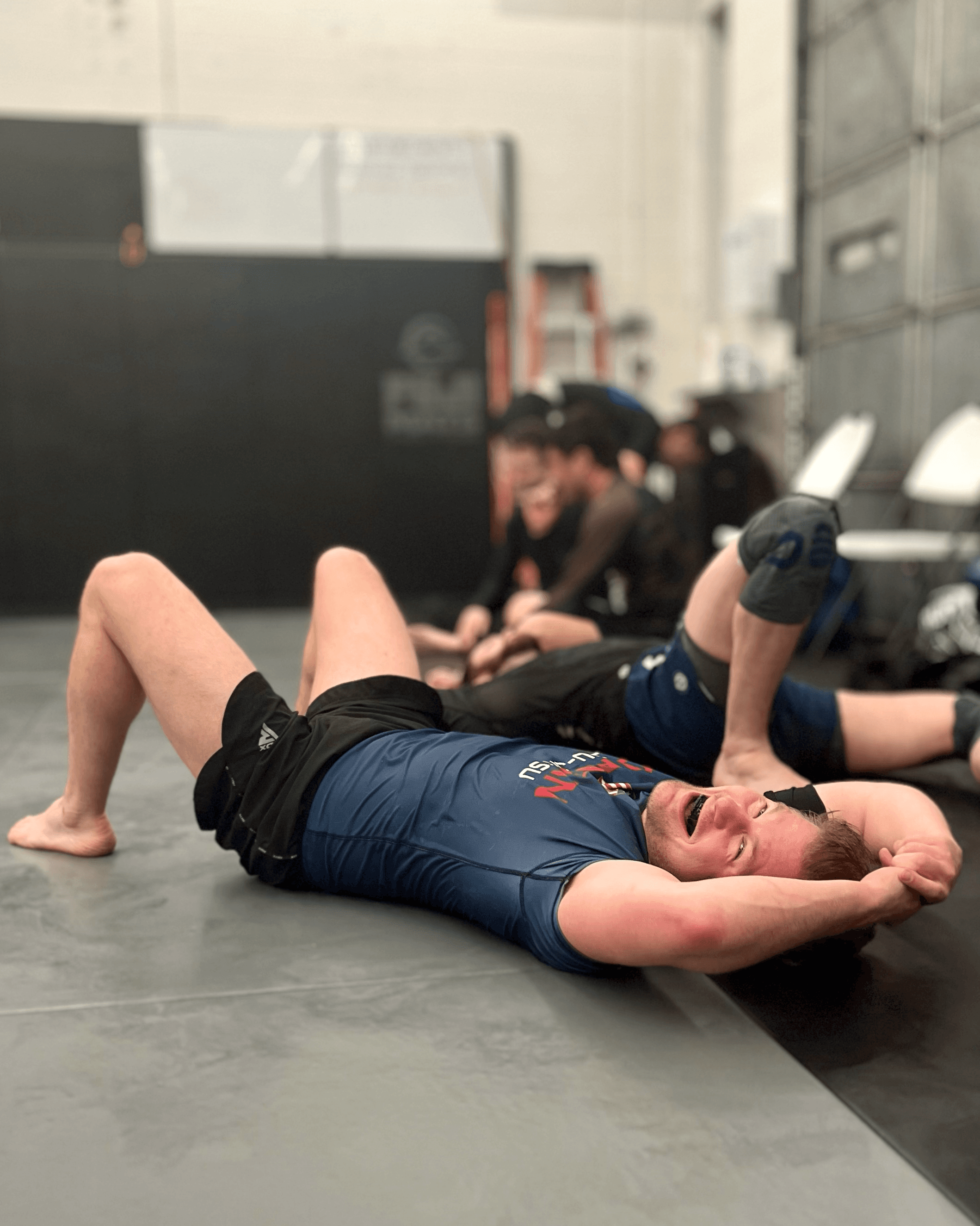 Student laying down after a hard Jiu-Jitsu round.